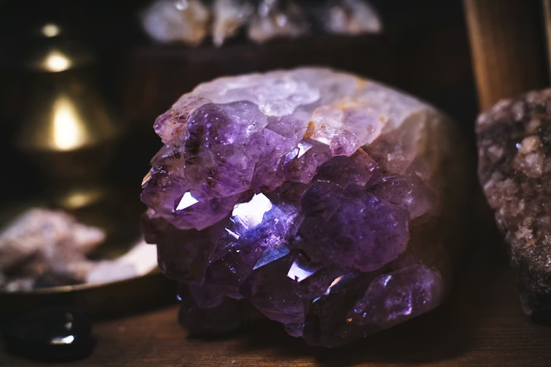 Amethyst crystal cluster in warm golden light