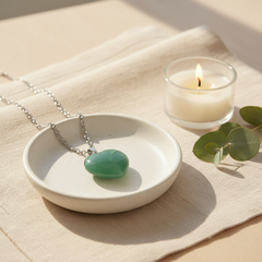 Green aventurine heart crystal necklace on ceramic dish with candle and eucalyptus — Mystical Gifts by Dufme609