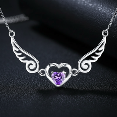 Close-up of 925 sterling silver angel wings crystal heart pendant with purple crystal embellishments and platinum plating