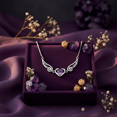 925 sterling silver angel wings necklace on dark velvet with amethyst crystals and dried flowers in mystical spiritual setting